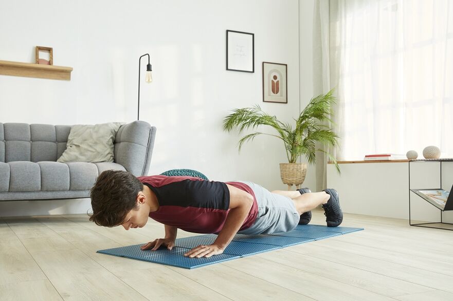 Stand in a plank position to exercise the muscles of the press and back