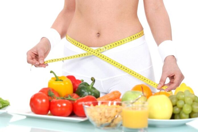 Girl measuring waist on grocery store background